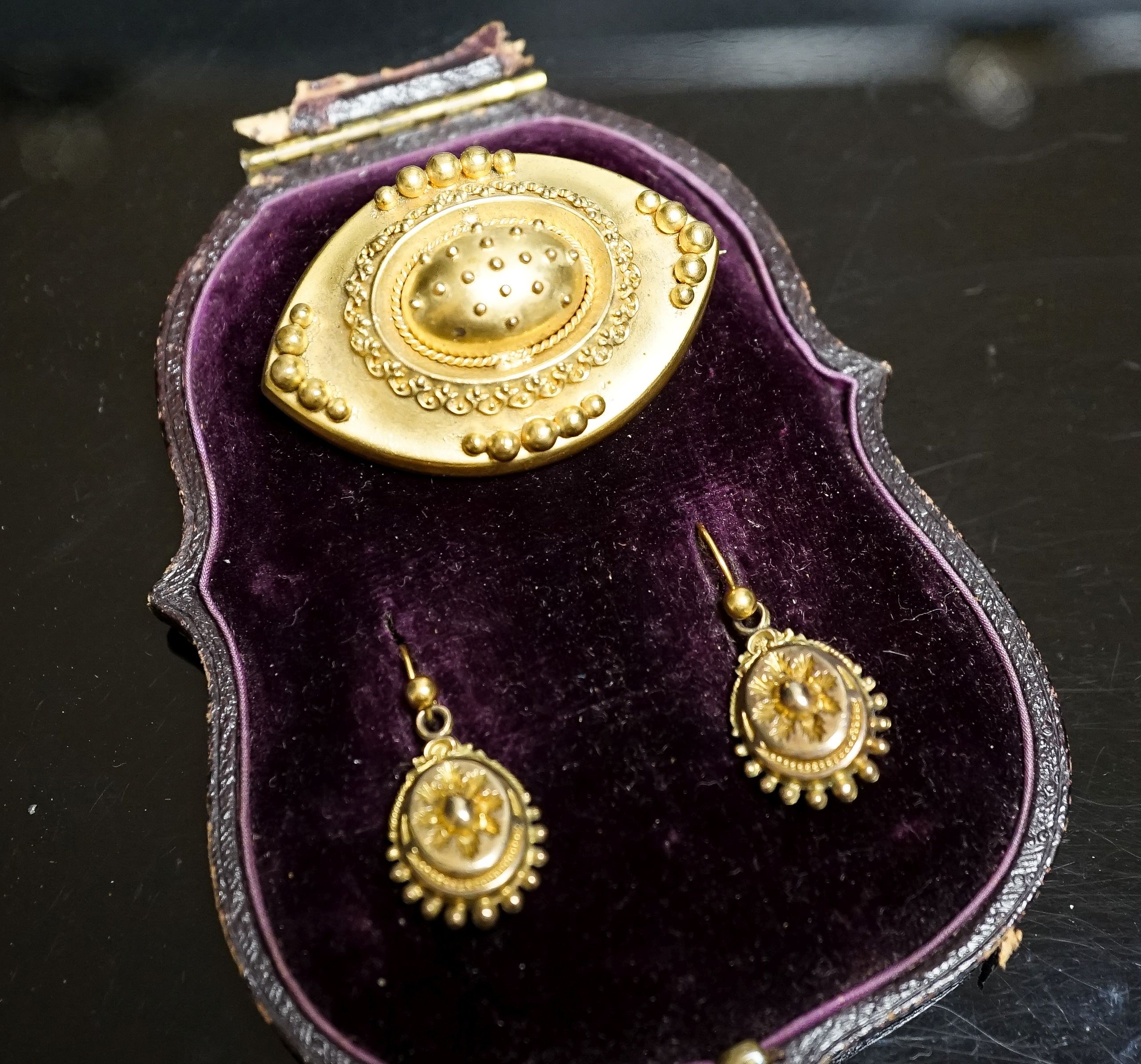 A Victorian yellow metal navette shaped brooch, with bead decoration, 46mm and a pair of similar drop earrings, 22mm, gross weight 17 grams.